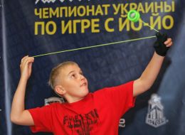 A boy plays with a yo-yo