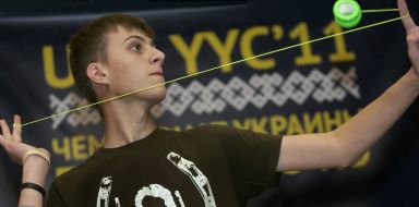 A boy plays with a yo-yo