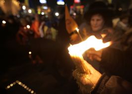 Opposition supporter holds a candle