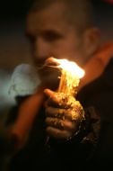 Opposition supporter holds a candle