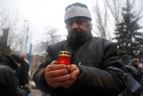 Chernobyl’s victim holds an icon lamp