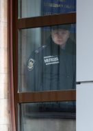 Співробітник міліції дивиться з вікна