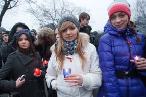 Participants of the mass meeting-requiem hold candles