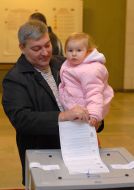 The elector gives up a bulletin in an urn for voting