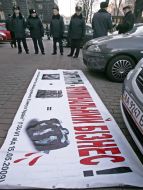 Militiamen near a placard