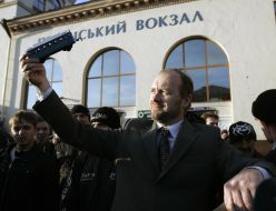 The participant of flashmob takes apart child's railway