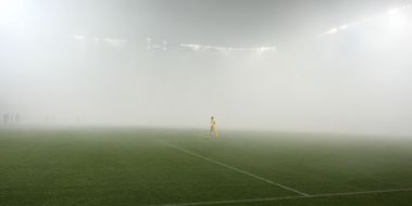 Smoke from smoke bomb on the field of stadium