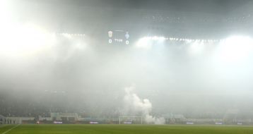 Smoke from smoke bomb on the field of stadium 