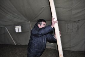 A businessman sets a tent