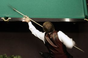 A man plays billiards