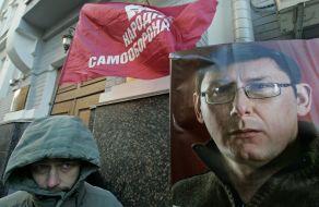 Man near the Lutsenko’s portrait