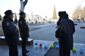 A militiamen stands near children' chamber pots