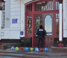 A militiaman stands near children' chamber pots