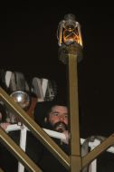 Moishe Moscovich lights lamps on the Menorah