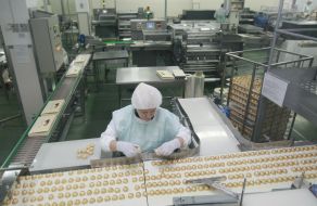 A workwoman lays out chocolate candies