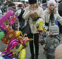 A woman buys a child a balloon