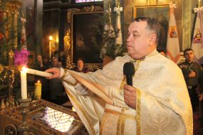 Father Yurіy Novitskiy lights a candle