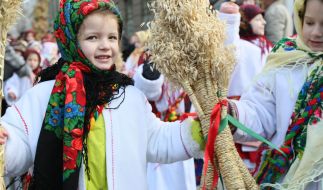 Girl holding a Christmas Didukh