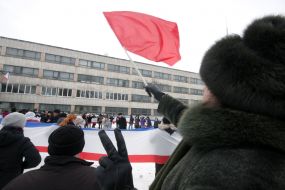 The woman holds the red flag 