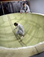 Workers prepare a form for making an Easter egg