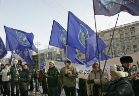 The participants of the mass meeting hold flags