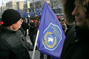 The participants of the mass meeting hold a placard