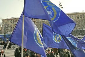 The participants of the mass meeting hold flags