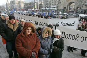 The participants of the mass meeting hold a placard