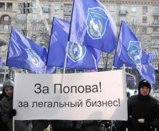 The participants of the mass meeting hold a placard