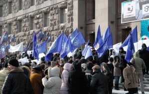 The participants of the mass meeting hold a placard