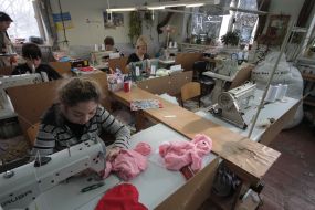 Workwoman on the factory of soft toys