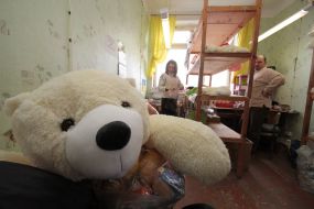 Workwoman on the factory of soft toys