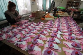 Workwoman on the factory of soft toys