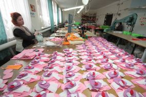 Workwoman on the factory of soft toys
