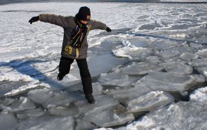 A boy tries to pass over ice