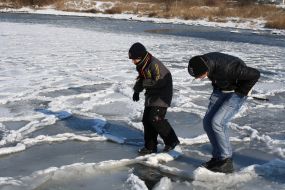 A boy tries to pass over ice