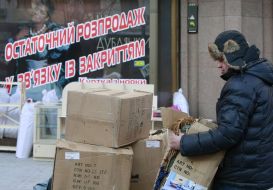 A businessman stands near the commodity