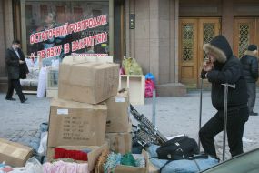 A businessman smokes near the commodity