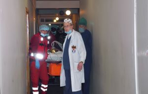 Medical workers drive gurney with a boy