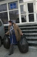 Сleaner takes away sacks with garbage