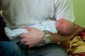 Richard Guinn holds a child