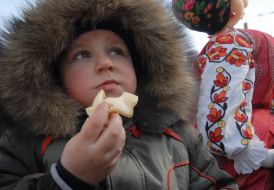 The boy eats a pancake