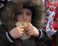 The boy eats a pancake