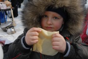 The boy eats a pancake