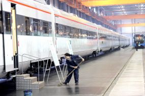 A cleaner washes a floor