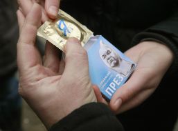 The participant of action holds a box with a contraceptive