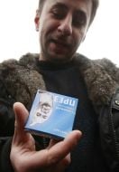 Sergey Melnichenko holds a box with a contraceptive
