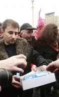 Sergey Melnichenko holds a box with a contraceptive
