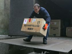 Loader unloads boxes of exhibits treasures of gold