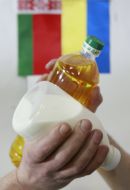 Sunflower-seed oil and milk on a background the small flags of Ukraine and Byelorussia